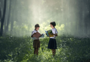 forest, trees, grass, two children in uniform, books